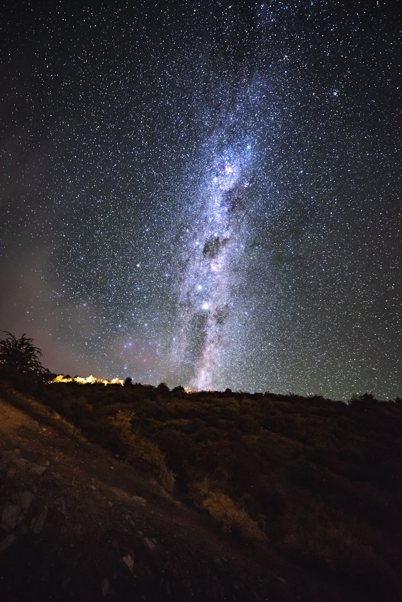 Star trails in the night sky over a dark landscape